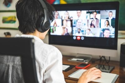 A person working at home having a video conference with colleagues